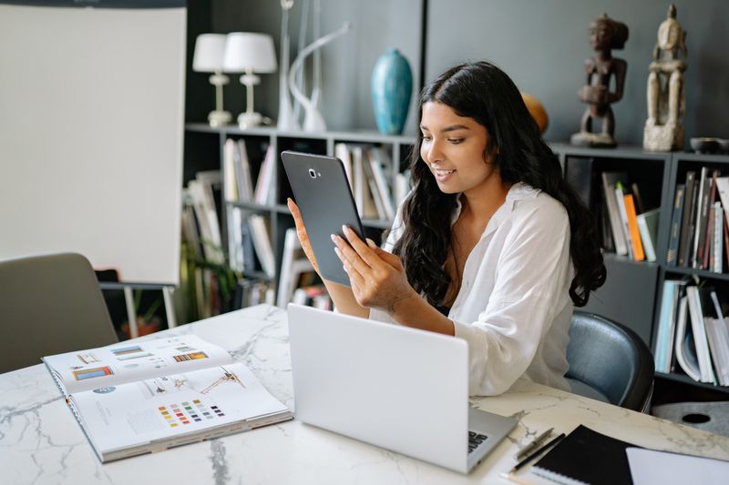 Property manager managing rentals on a tablet and laptop